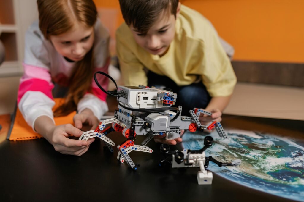 Two young students working on a robotics project
