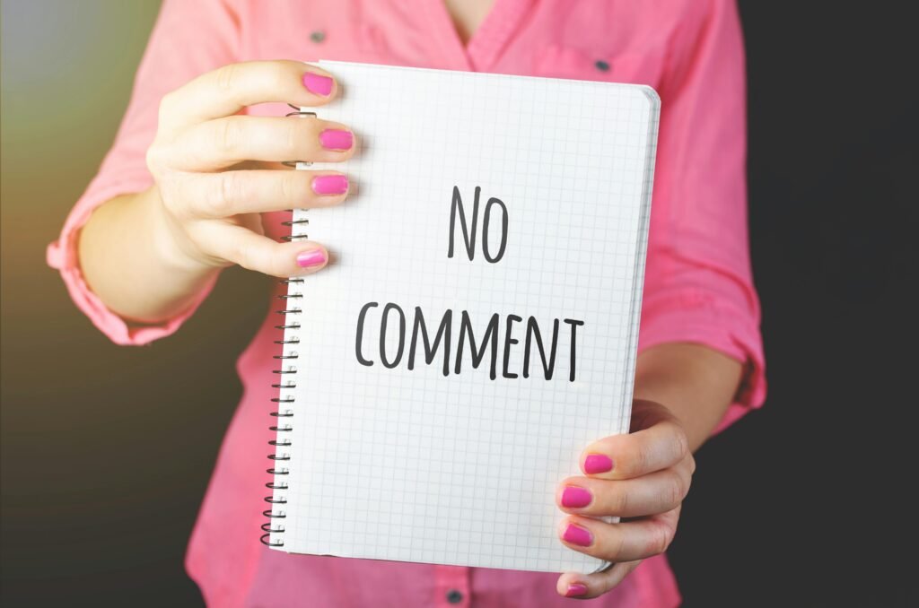 No comment spelled out on notebook held by a woman