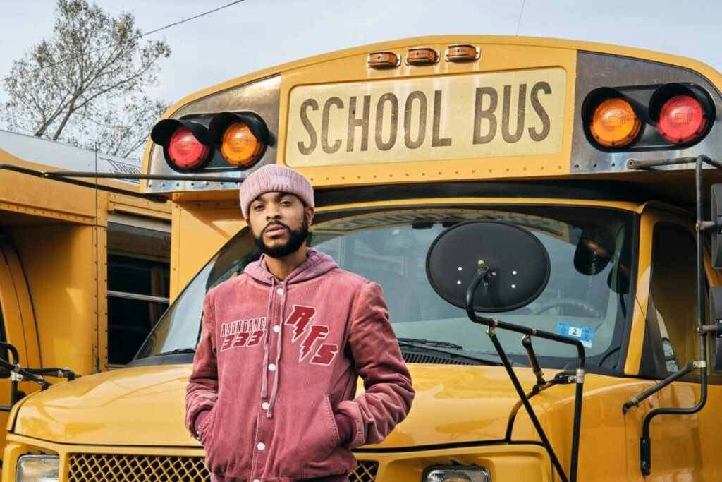 Man standing in front of school bus