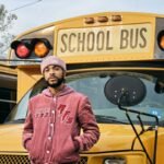 Man standing in front of school bus