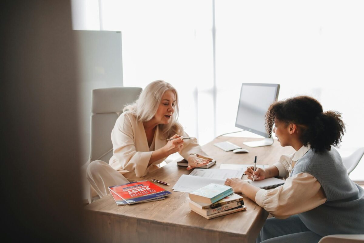 Adult and child at desk having a discussion