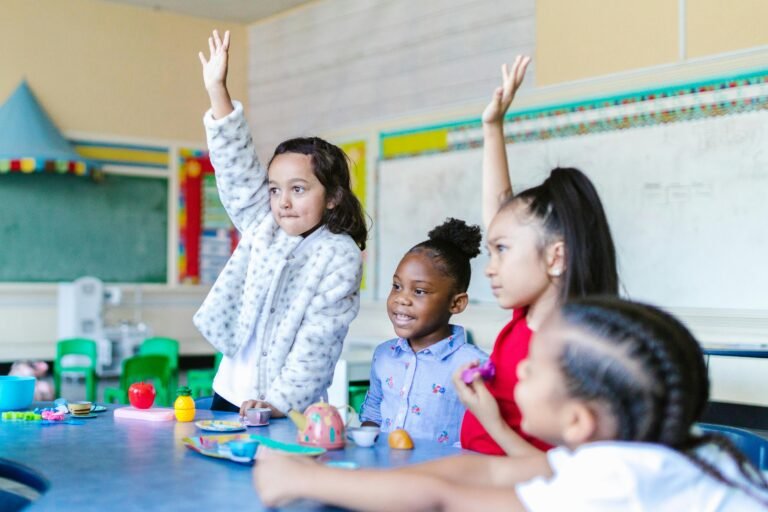 Group of young students with two raising their hands