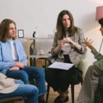 Adult with students having a discussion