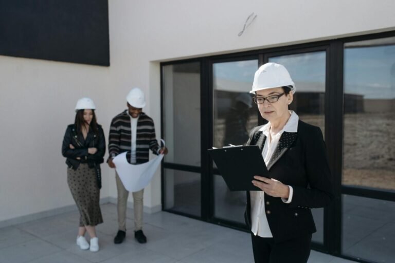 People in front of school building wearing hard-hats.
