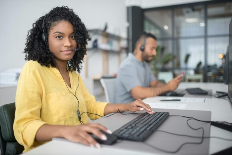 Young female providing IT support via phone.