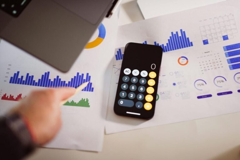 Finance related papers and calculator on top of a desk.