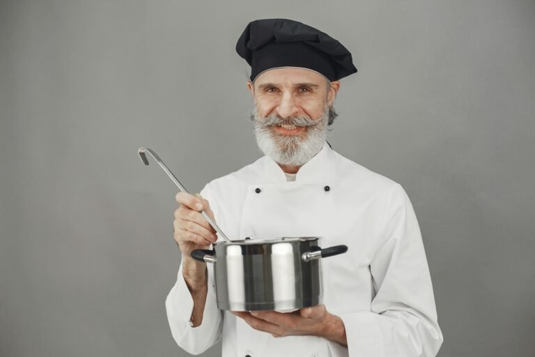 School cook holding a pot.