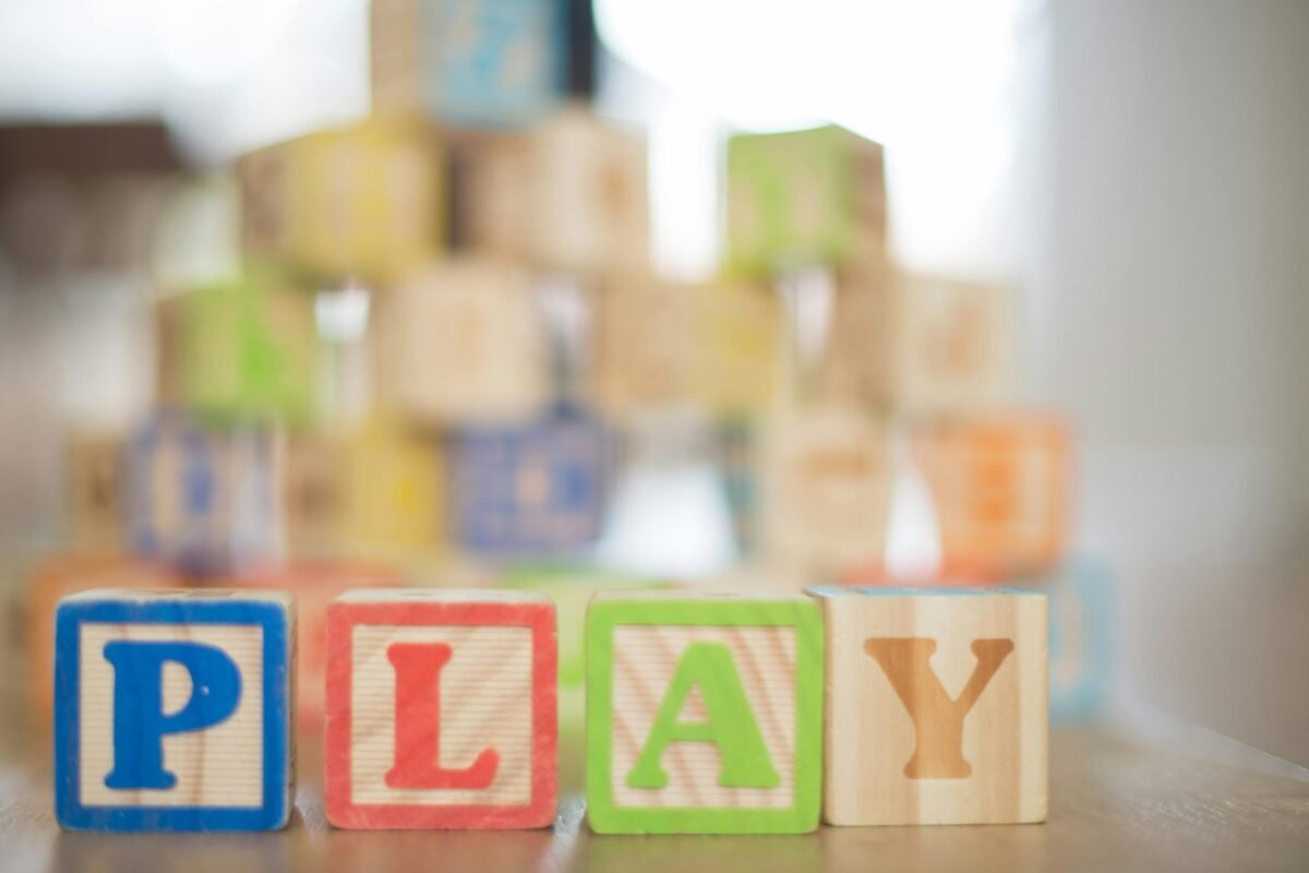The word play spelled out in wooden blocks.