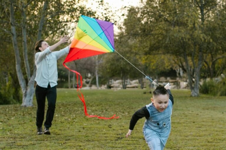 Camp counselor and camper playing with a kite.