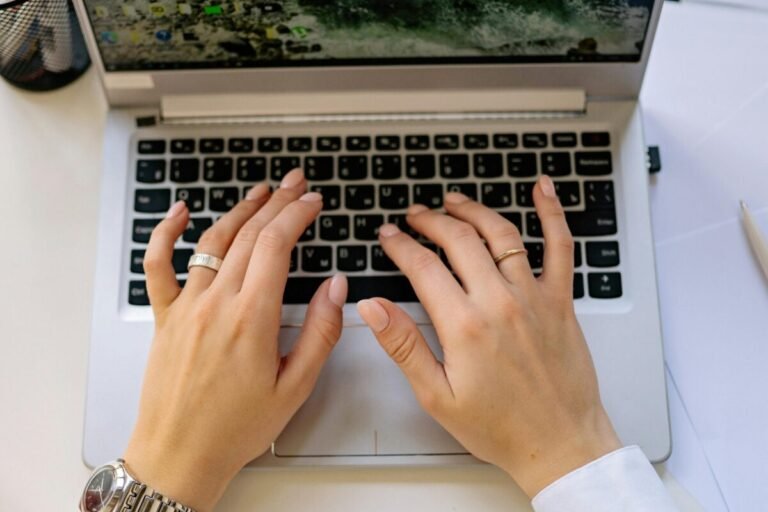 Person using a computer to write a resume.