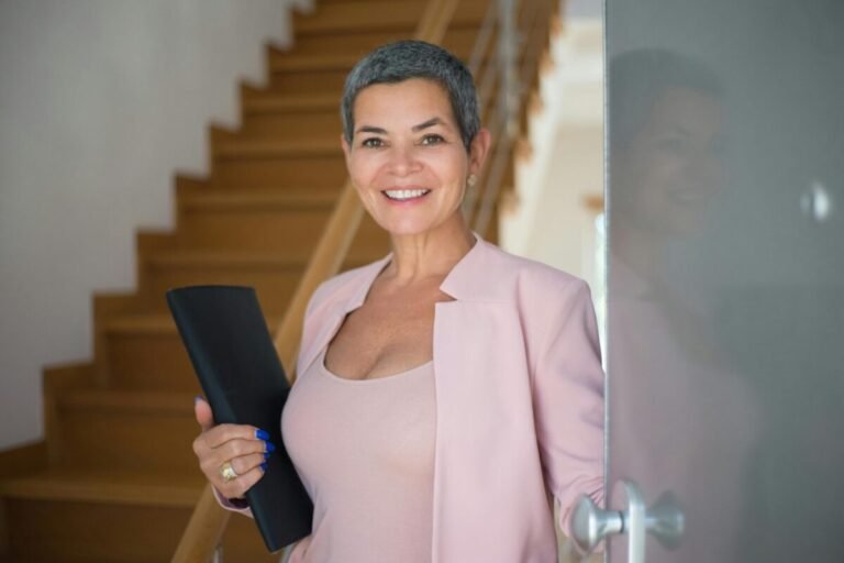 School leader in front of staircase.