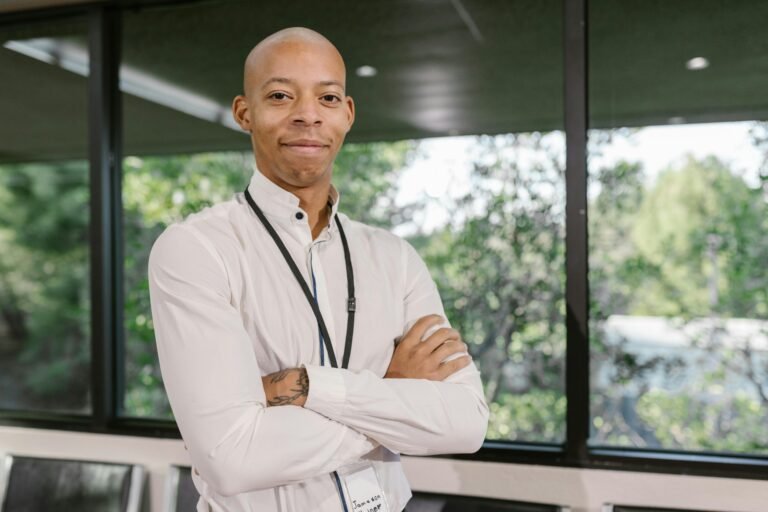Person standing with arms crossed.