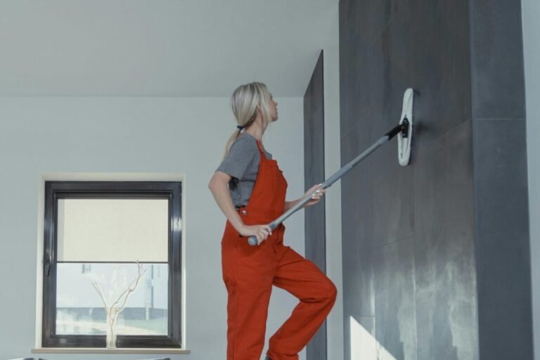 School custodian painting a wall.