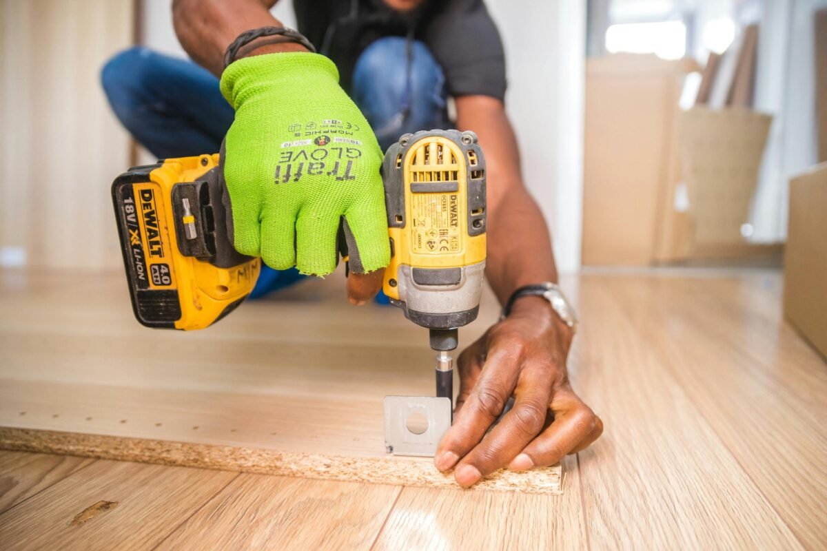A school custodian making repairs in a classroom.