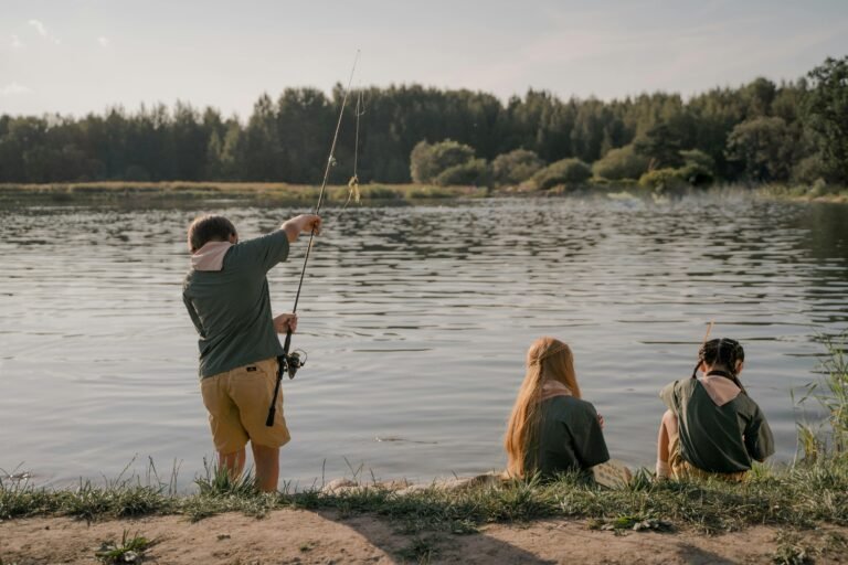Summer campers fishing as seen from the view of the summer camp counselor.