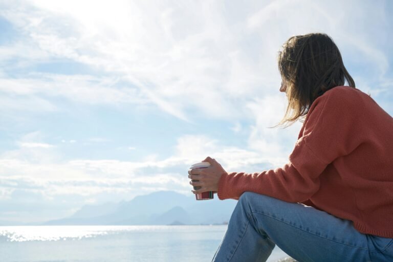 Person conducting self-reflection as they look out into the lake.