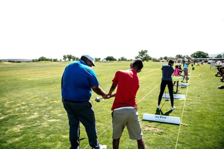 Junior Varsity coach working with student athletes on their golf skills.