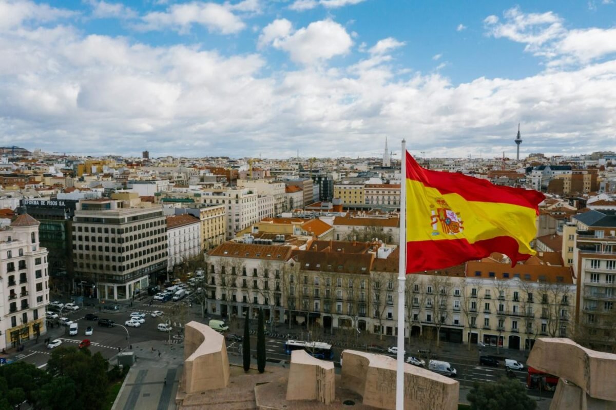 Flag flying above Spain where Spanish is the official language.