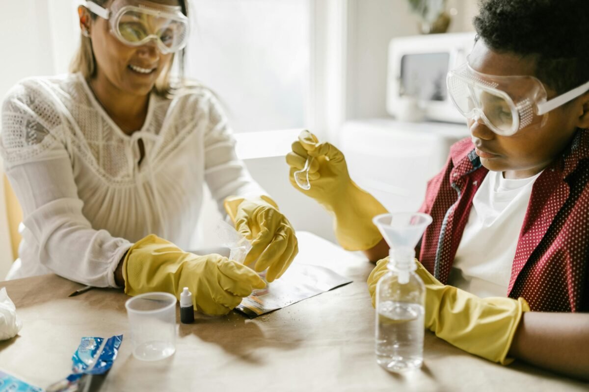 Teacher's aide working on a science experiment with a student in school.