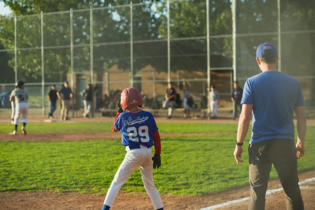 Recreational league coach at baseball game.