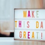 Board that reads "make this day great"
