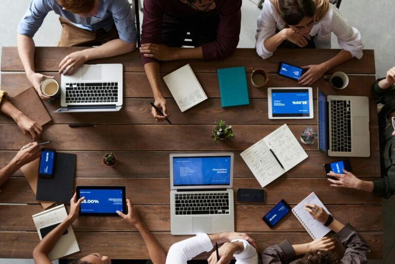 Group of people using technology to build a website